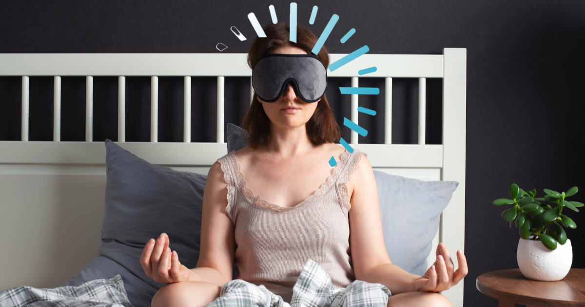 Woman meditating in bed with a sleep mask, symbolizing a calm nighttime routine and natural ways to sleep better | Sip2Sleep®
