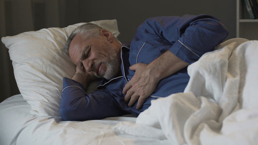Old man having heart attack, suffering sharp chest pain while sleepin
