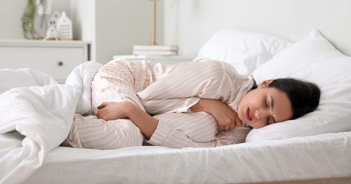 Woman experiencing sleep discomfort during period