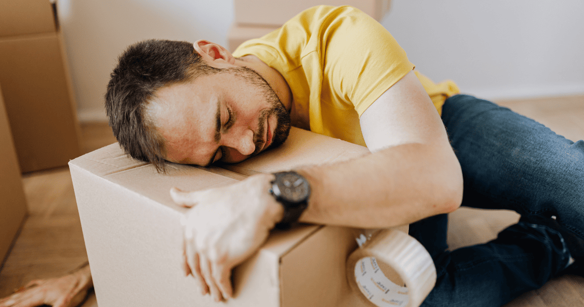 Tired man fall asleep on carton box